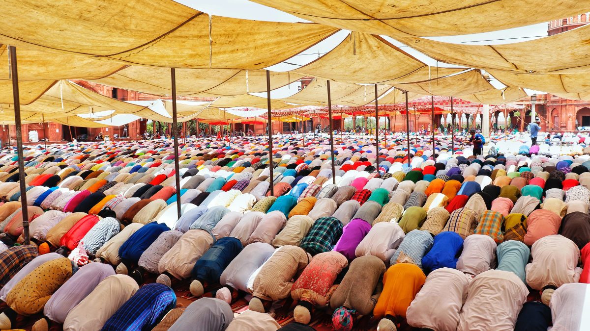 people bowing down inside canopy during day