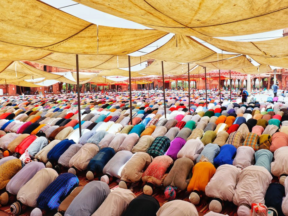 people bowing down inside canopy during day